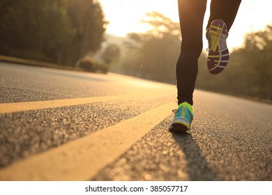 young fitness woman runner athlete running at road - Shutterstock ID 385057717