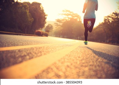 young fitness woman runner athlete running at road - Shutterstock ID 385504393