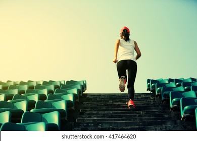 young fitness woman runner athlete running up on stairs.