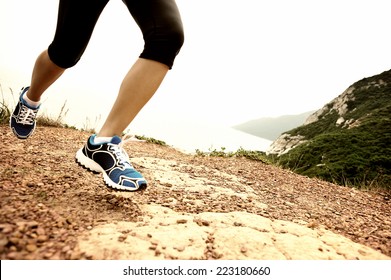 Young Fitness Woman Runner Legs Running On Seaside Mountain Trail