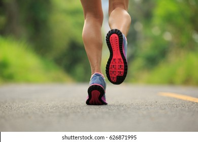 Young Fitness Woman Runner Legs Running On Tropical Forest Trail