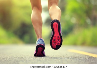 Young Fitness Woman Runner Legs Running On Forest Trail