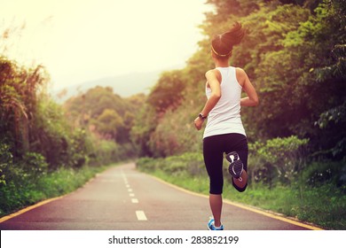 young fitness woman runner running on trail - Shutterstock ID 283852199