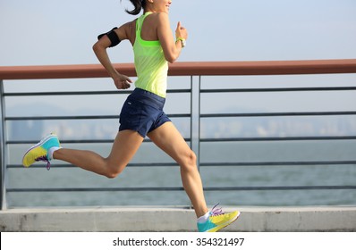 young fitness woman runner running at seaside - Shutterstock ID 354321497