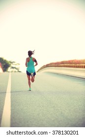 young fitness woman runner running on road - Shutterstock ID 378130201