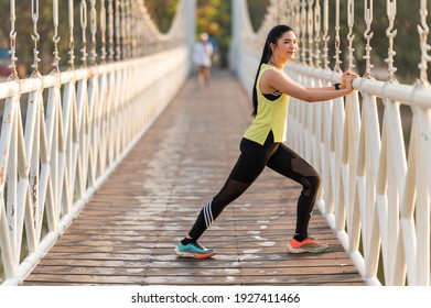 Young Fitness Woman Runner Stretching Before Run On The Park