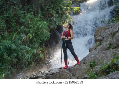 Young Fitness Woman Running At Forest Trail On Waterfall Background