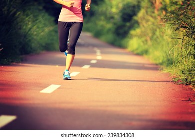 Young Fitness Woman Running At Forest Trail 