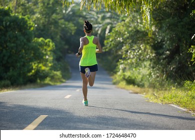 Young Fitness Woman Running O Tropical Forest Trail