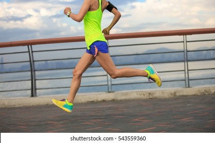 young fitness woman running at seaside - Shutterstock ID 543559360