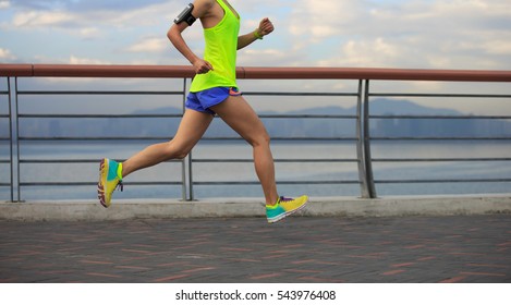 young fitness woman running at seaside - Shutterstock ID 543976408
