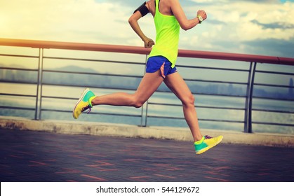 young fitness woman running at seaside - Shutterstock ID 544129672