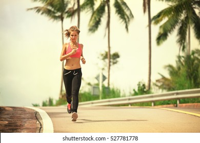 Young Fitness Woman Running At Tropical Forest Trail