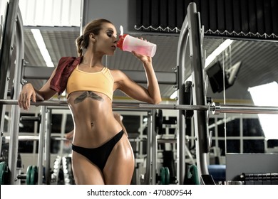 Young Fitness Woman Tired In Gym Drink Sportive Nutrition , Amino Acid Or Bcaa Of Shaker , Horizontal Photo