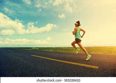 Young Fitness Woman Trail Runner Running On Road