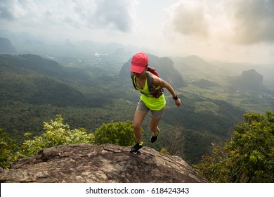 Young Fitness Woman Trail Runner Running At Mountain Top