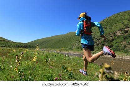 Young Fitness Woman Trail Runner Running On Riverside 