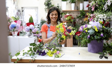 Young florist working at the flower shop and making a beautiful arrangement - Powered by Shutterstock