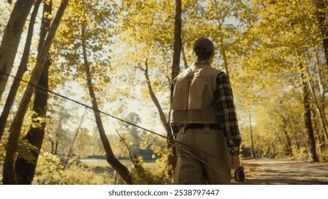 Young fly fisherman walking to a river at dawn - Powered by Shutterstock