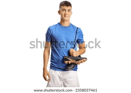 Young football player carrying cleats on his shoulder isolated on white background