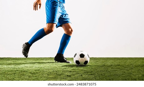 A young football player stands on the playing ground, wearing a team shirt and socks. The vibrant field and uniform highlight his passion and readiness for the game. - Powered by Shutterstock