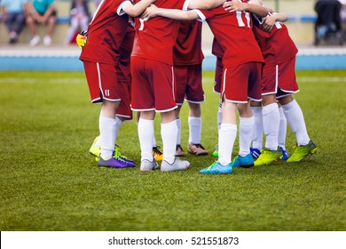 Young Football Soccer Players In Red Sportswear. Young Sports Team On Pitch. Pep Talk Before The Final Match. Soccer School Tournament. Children On Sports Field.