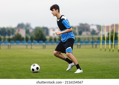 Young Footballer Running Ball During Soccer Training Unit. Football Education for Youths - Powered by Shutterstock