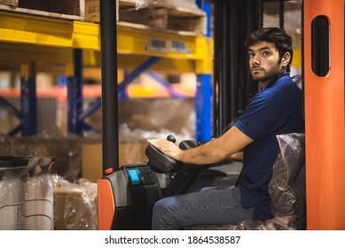 Young forklift driver sitting in vehicle in warehouse - Powered by Shutterstock