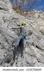 A Young Free Climber Climbs On A Cliff
