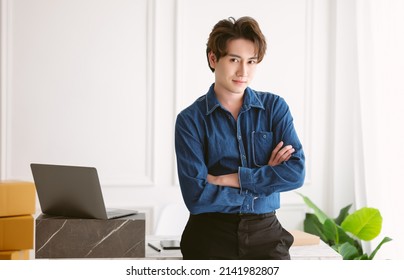 Young Freelance Asian Casual Man Working Small Business Owner Standing Arm Cross, Looking At Camera And Smiling At Home Office. Start Up Small Business Entrepreneur SME, Selling Online Ideas Concept.