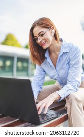 Young Freelancer Woman Online Communicating By Laptop And Hands Free Headset