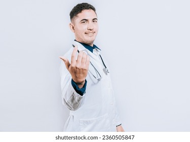 Young friendly doctor inviting to come on white background. Smiling doctor inviting to come isolated - Powered by Shutterstock