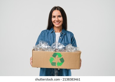 Young friendly eco-activist woman girl sorting garbage, holding carton box full of plastic bottles for preserving saving environment nature protection, plastic resycling isolated in white - Powered by Shutterstock