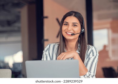 Young friendly operator woman agent with headsets working in a call centre. - Powered by Shutterstock