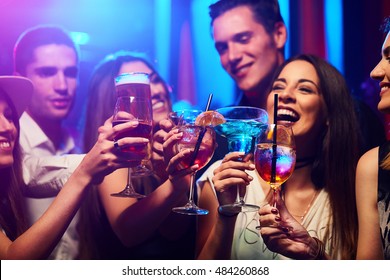 Young Friendly People Toasting In Night Club