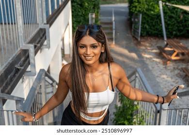 young friendly smiling teen girl posing on iron ladder of outdoor country restaurant - Powered by Shutterstock