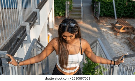 young friendly smiling teen girl posing on iron ladder of outdoor country restaurant - Powered by Shutterstock