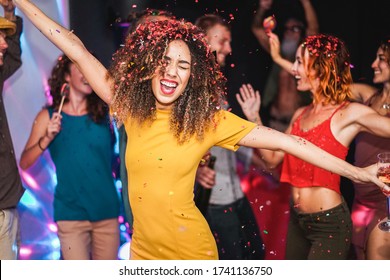 Young Friends Dancing At Home Private Party - Happy People Having Fun Listening Music And Drinking Champagne At Night - Alternative Fest During Coronavirus Time - Focus On Afro Hair Girl Face