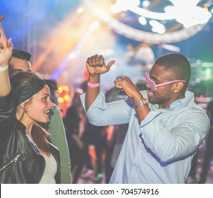 Young Friends Dancing At Party In Night Club - Soft Focus On Black Man