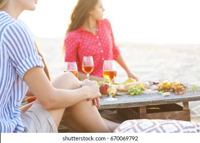 Young Friends Drinking Rose Wine On Summer Beach Picnic. Summer Vacation And Party Concept