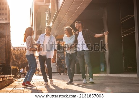 Young friends hang out on the city street.They go for walks together and have fun in the city downtown.