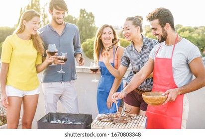 Young Friends Having Barbecue Party At Sunset On House Patio - Happy People Doing Bbq Dinner Outdoor Cooking Meat And Drinking Wine - Main Focus On Right Man Face - Food, Fun And Friendship Concept 