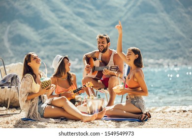 Young friends having fun at the beach on a sunny day.