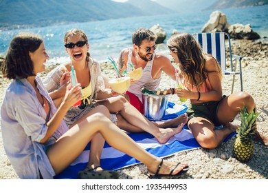 Young friends having fun at the beach on a sunny day. Party time. - Powered by Shutterstock