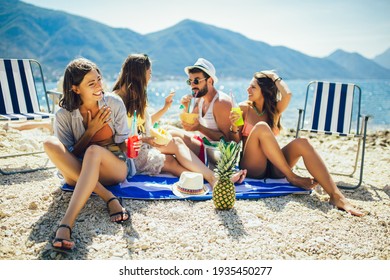 Young friends having fun at the beach on a sunny day. Party time.