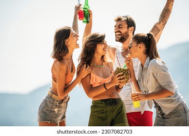 Young friends having fun at the beach on a sunny day. - Powered by Shutterstock