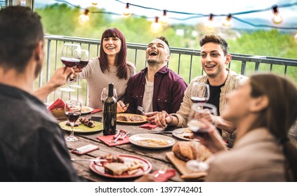 Young Friends Having Fun Drinking Red Wine At Balcony Penthouse Dinner Party - Happy People Eating Bbq Food At Fancy Alternative Restaurant Together - Dinning Lifestyle Concept On Warm Vintage Filter