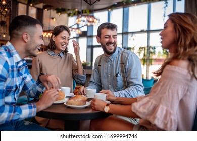 Young Friends Having A Great Time In Restaurant. Group Of Young People Sitting In A Coffee Shop ,drinking Coffee.