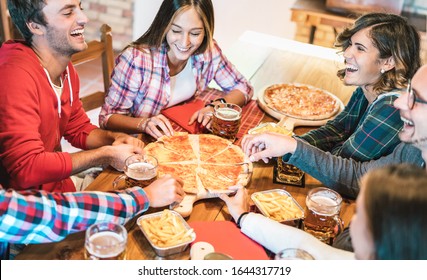 Young Friends On Genuine Laugh While Eating Pizza At Home On Family Reunion - Friendship Concept With Happy People Enjoying Time Together Having Fun At Pizzeria Drinking Brew Pints - Warm Vivid Filter