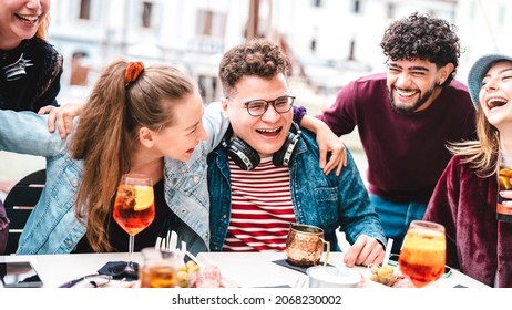 Young Friends On Genuine Laugh Moment At Fancy Pub Restaurant - Life Style Concept With Multicultural People Having Fun Together On Happy Hour At Sidewalk Cafe - Vivid Filter With Focus On Central Guy